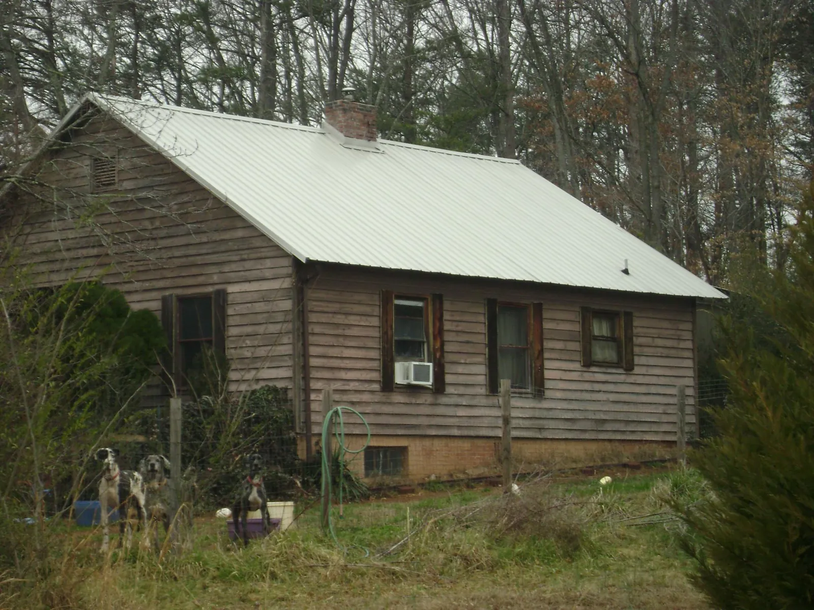White metal roof on an old wood sided farmhouse, from a Metal Roof Installation job in Plymouth